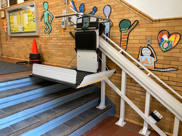Syracuse-NY-Commercial-Wheelchair-Lift-Garaventa-from-Syracuse-Elevator-side-view-image-of-white-and-black-school-platform-lift