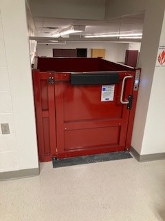 Syracuse-NY-Commercial-Wheelchair-Lift-Garaventa-Genesis-from-Syraucse-Elevator-closed-door-top-view-image-of-red-wheelchair-lift