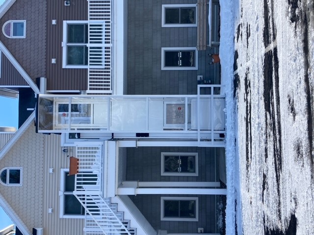 Syracuse-NY-Residential-Wheelchair-Lift-Garaventa-Alexandria-Bay-NY-from-Syracuse-Elevator-front-view-image-of enclosed-white-wheelchair-lift